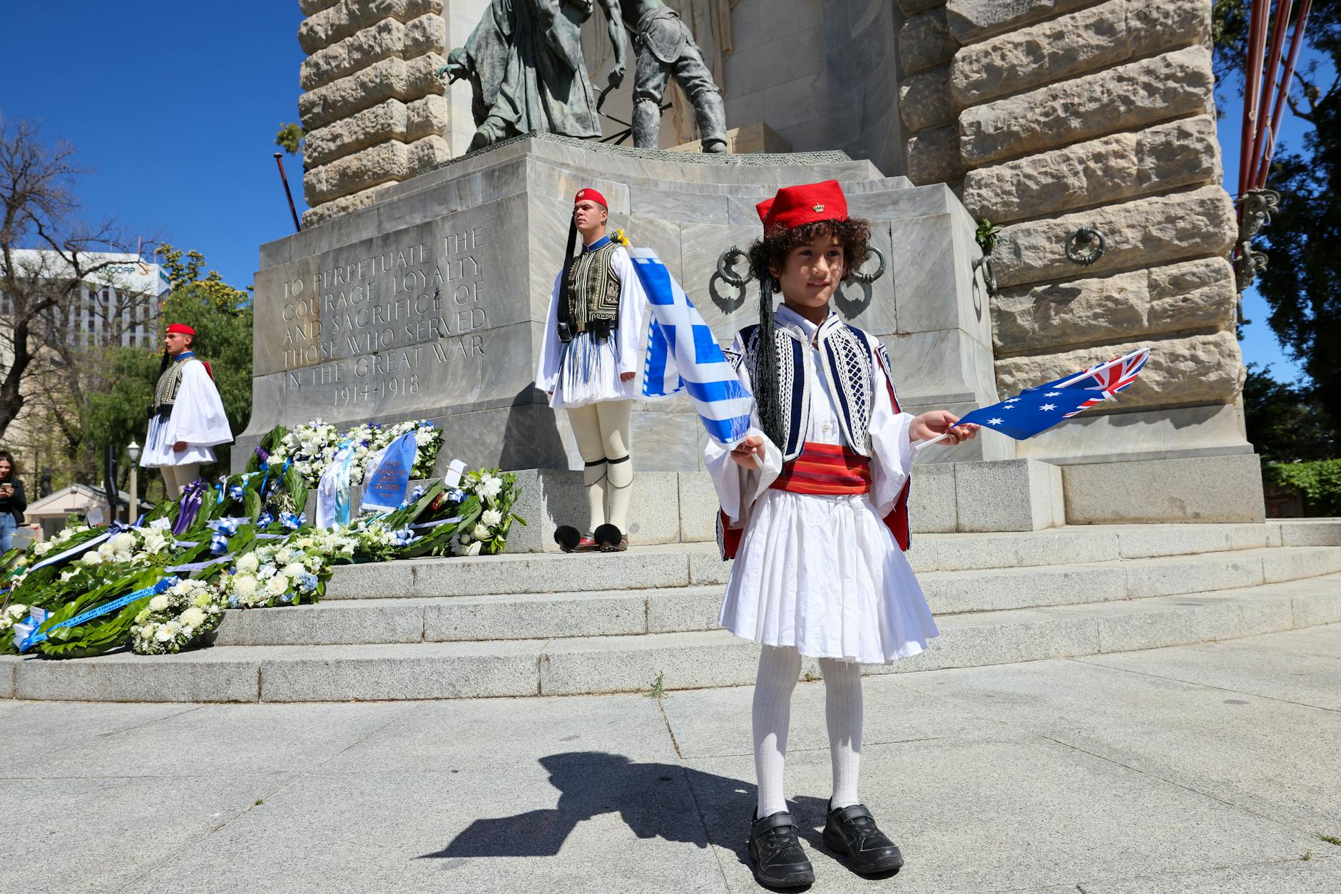Young boy in traditional Greek clothing at independence day celebration.