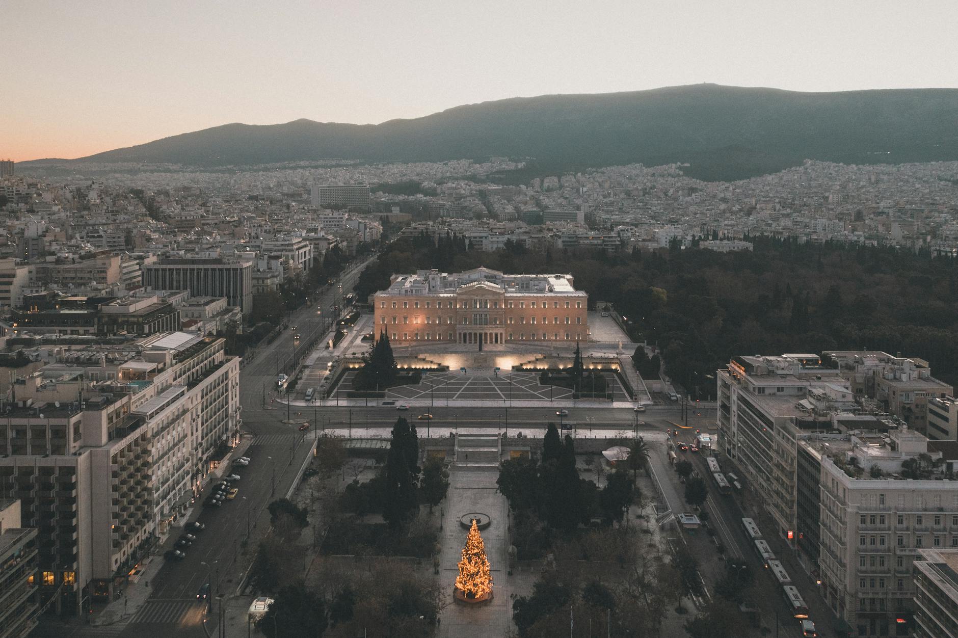 Scenic aerial view of Syntagma Square, Athens, Greece, illuminated at dusk with a Christmas tree.