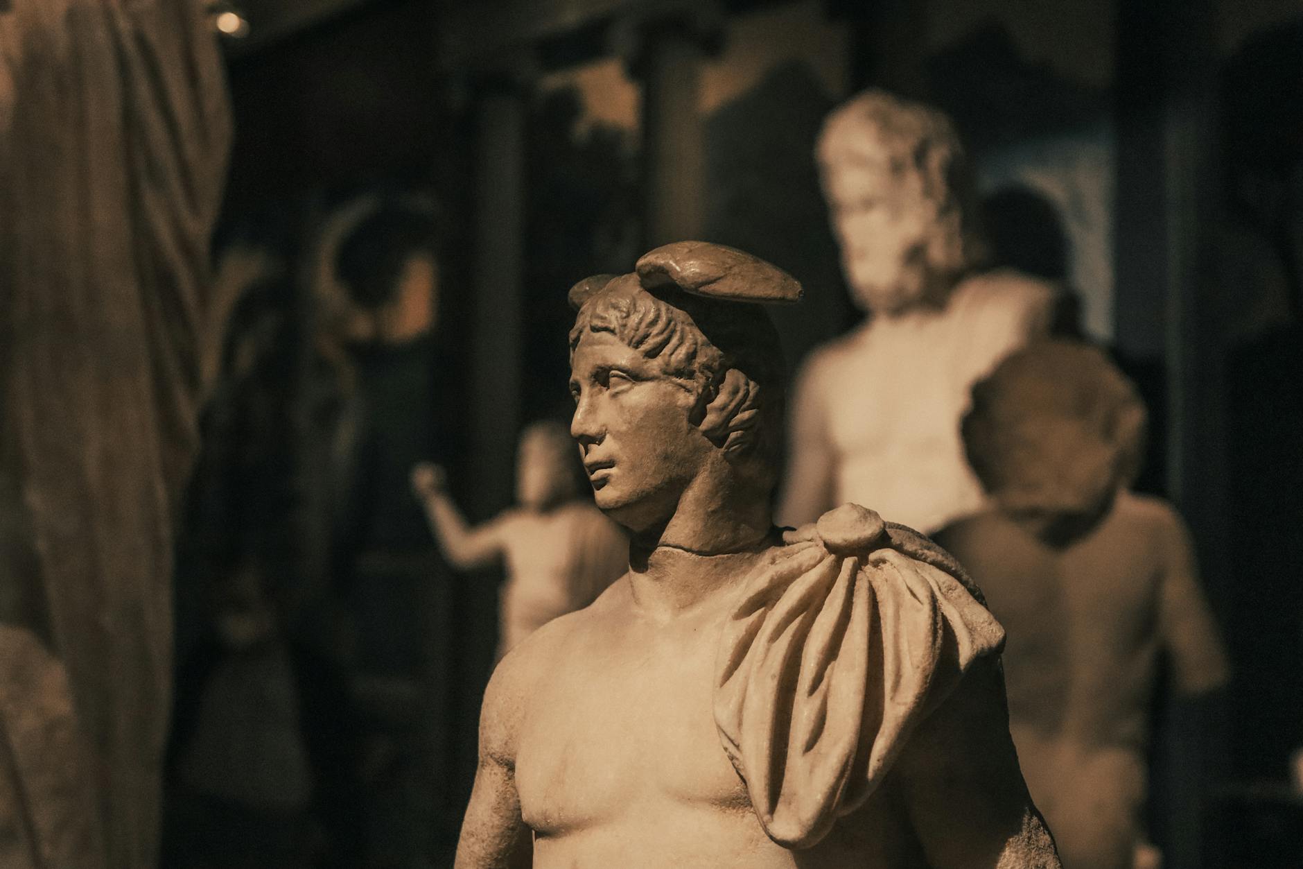 Close-up of ancient Greek-Roman statue in a museum, showcasing classical artistry.